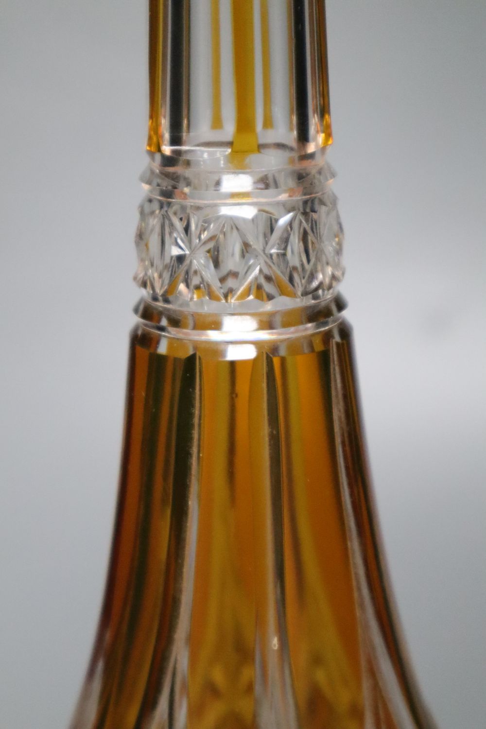 A tall amber-flashed glass decanter and clear stopper, height 48cm